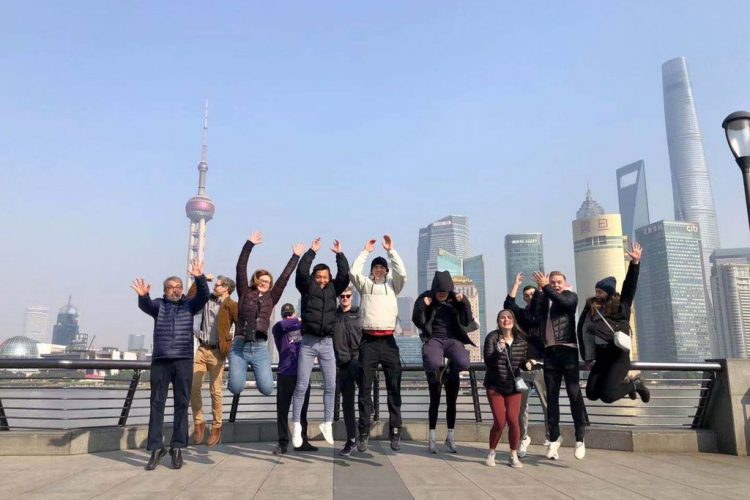 Students and faculty in the 2019 Economics and Business 321 course jump for joy in China.