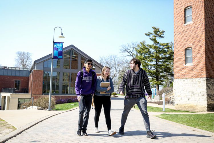 Three students walk together on the Ped Mall