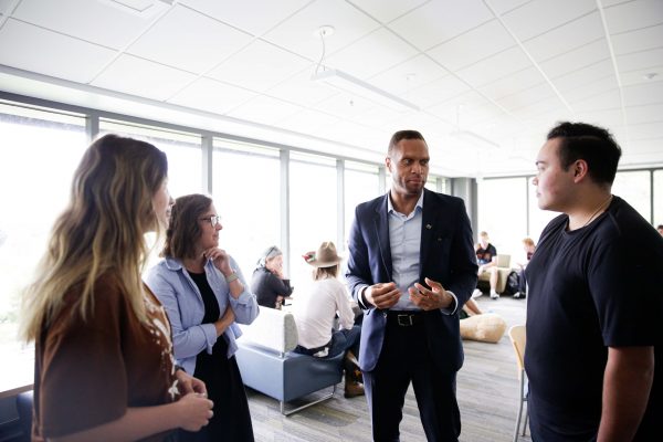 Linn County Supervisor Stacey Walker (center) talks with Nick Schwartz (right), Assistant Professor of American Politics Megan Goldberg, and Savannah Sheffler (left)