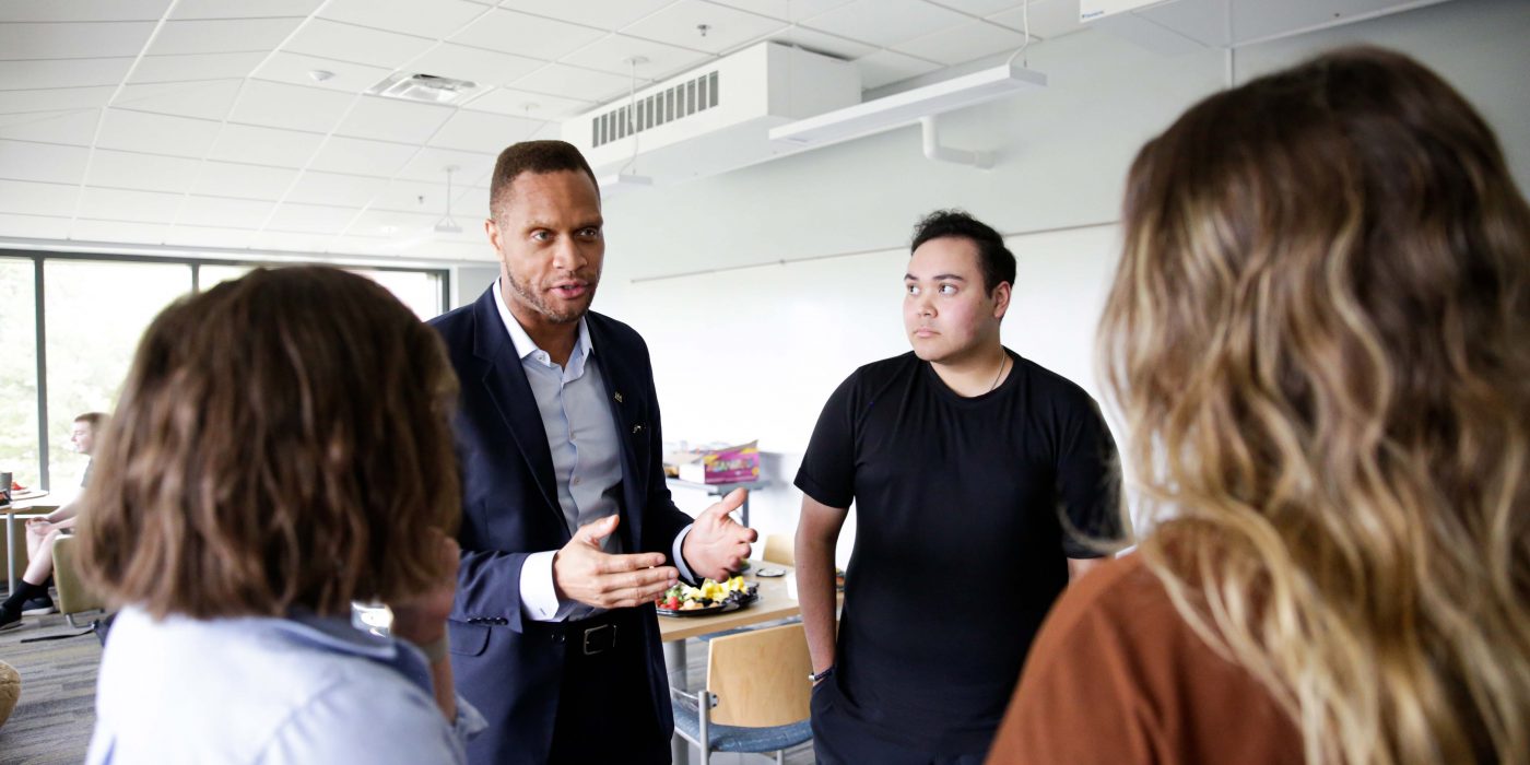 Linn County Supervisor Stacey Walker talks with Nick Schwartz , Assistant Professor of American Politics Megan Goldberg, and Savannah Sheffler