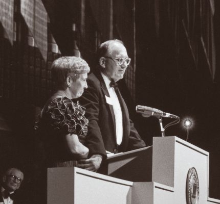 Richard and Norma small standing behind a podium 