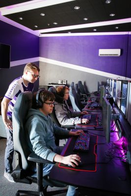 Jack Castiglione working with teammates in the Cornell College Esports Arena