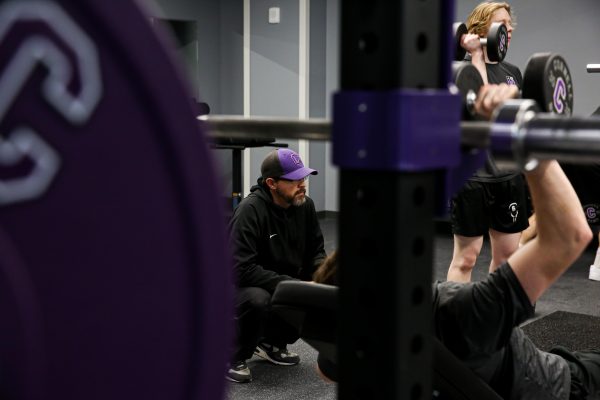 Lamb watches as the lacrosse team trains in the weight room.