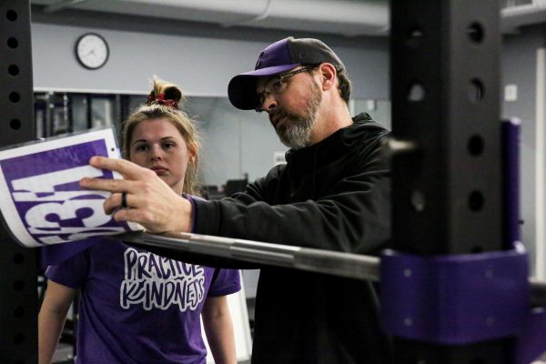 Curt working wit a volleyball player on the training plan for the day.