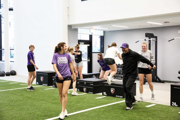 Curt joking with a volleyball player before their training session.