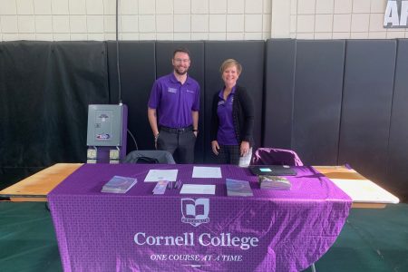 Sharon Grice and Senior Admission Representative Ryan Wiley at a table with a Cornell College tablecloth