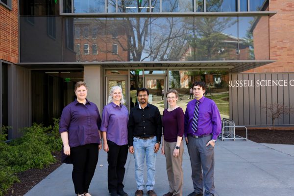 Five faculty members standing in front of Russell Science Center on the Cornell College campus.