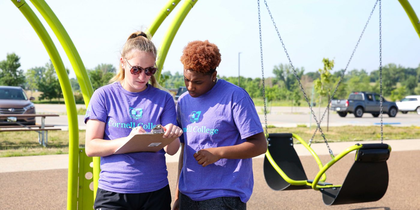 Senior Kaylynn Sparks (left) and rising sophomore A'ryn Jackson study the features on a playground in Linn County.