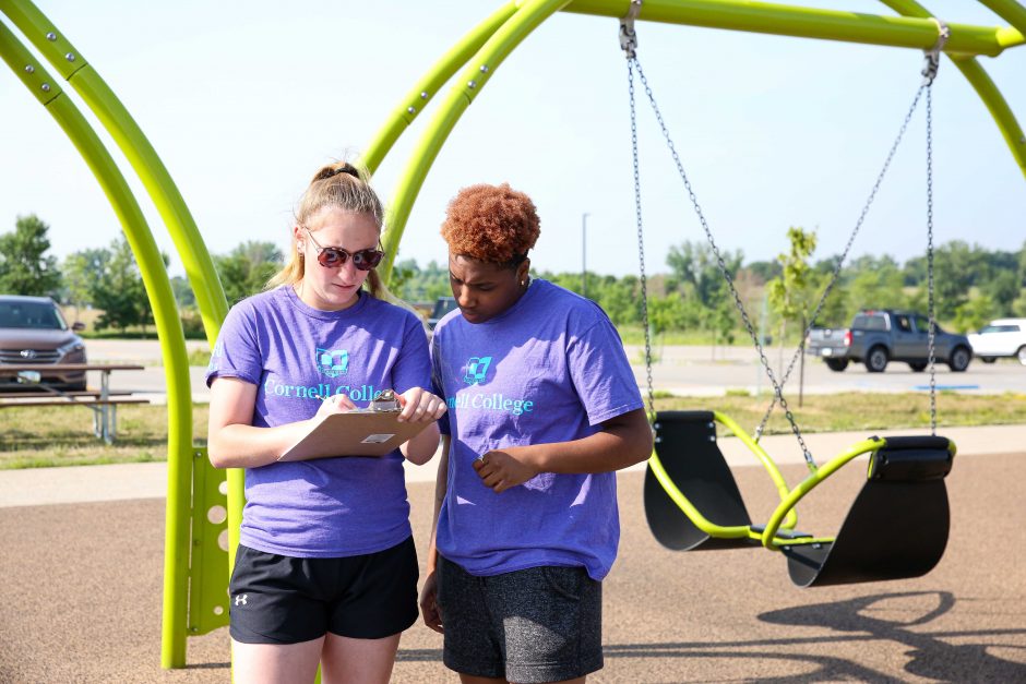 Senior Kaylynn Sparks (left) and rising sophomore A'ryn Jackson study the features on a playground in Linn County.