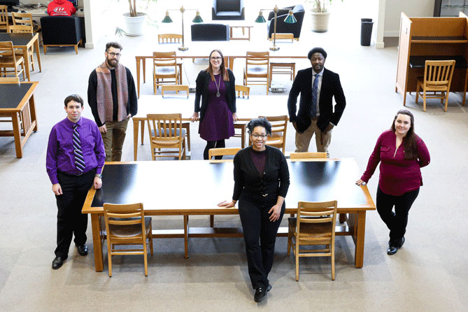 Six faculty pose together in Cole Library.