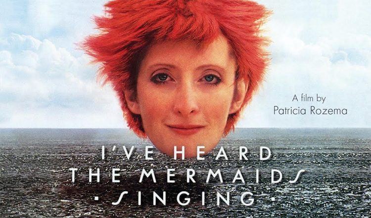 movie poster of a floating head of a wmoan with brigth red hair and blue eyes floating over an ocean, with the title "I've Heard the Mermaids Singing". The text on the left says "A film by Patricia Rozema