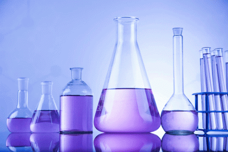 image of different glass bottles holding purple chemicals