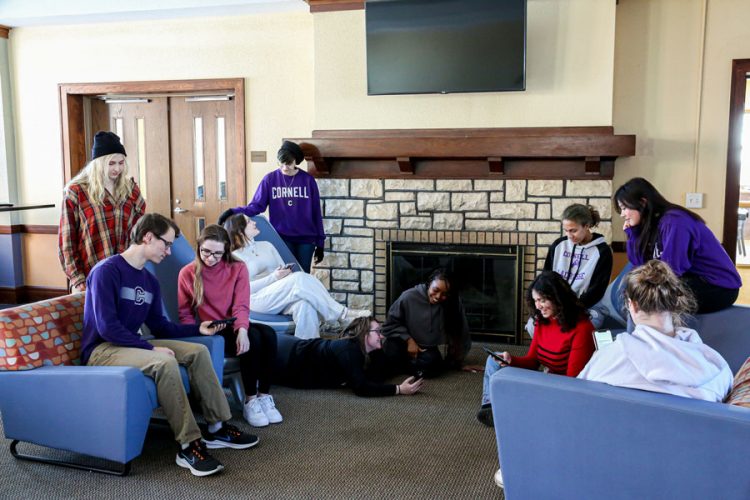 Take two — we have these 11 students recreating the archival photo in Pfeiffer Lounge. Standing from left: Lillian Leon ‘25 and Adrien Kaplan ‘25. Seated from left: Ben Parkins ‘24, Makayla Kelleher ‘23, Elifsude Degirmenci ‘26, Alejandra Villegas-Tshuma ‘24, Marley Gillespie ‘26, Anna Methe ‘24. Kaylanna Seu ‘25, and Tess Cooper ‘25 (back to camera). Reclining on the floor: Kylee Marzullo ‘25.