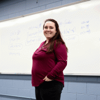 danielle grimes headshot in front of whiteboard