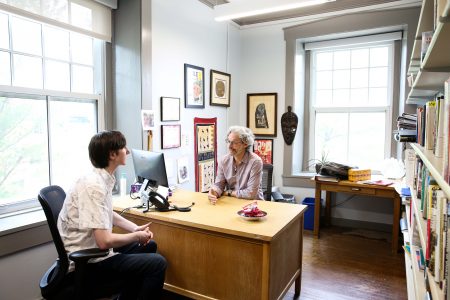 Indigo Meads (left) meets with Professor of Economics and Business Todd Knoop to discuss their research.