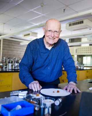 Ault visits the chemistry labs in 2018, inspecting the crystals made by students doing his lab experiment.