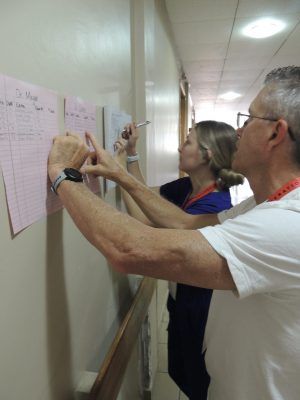 Samantha updating the physical therapy patient log.