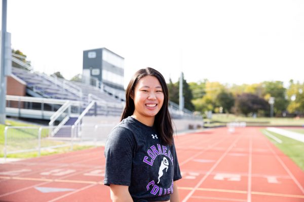 Photo of Caitlyne Mar smiling at the camera on the Cornell College outdoor track.