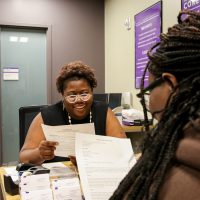 Kachana Myrville assists a student at the Berry Career Institute. Photo by Megan Amr.