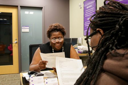 Kachana Myrville assists a student at the Berry Career Institute. Photo by Megan Amr.