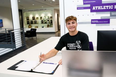 Wrestler Gabriel Smith ’26 works the SAW front desk, where he enjoys e