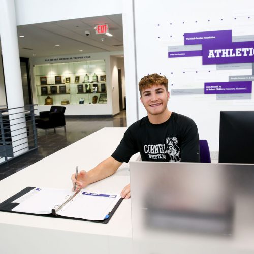 Wrestler Gabriel Smith ’26 works the SAW front desk, where he enjoys engaging with faculty, staff, and students who come in for a workout. Photo by Megan Amr.