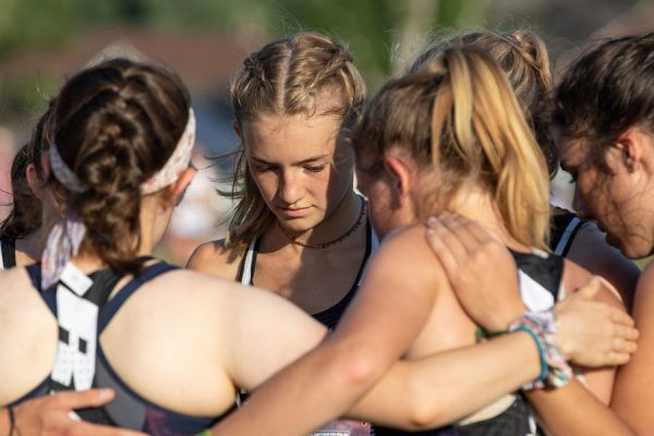 Katie Lammers '25 has a quiet moment with her cross country teammates. Cornell Sports Information photo.