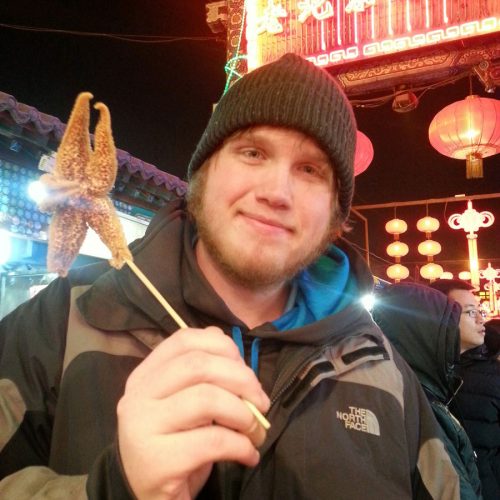 Rick Simkins ’15 tried starfish at an outdoor food market in China. Photo courtesy of Rick Simkins ’15.