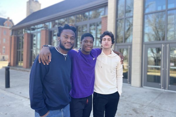 Three students standing in front of the Thomas Commons on the Cornell College campus.