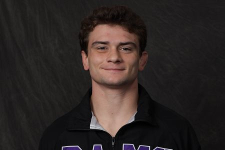 Landon Card smiling at the camera for a photo wearing a Cornell Rams sweatshirt