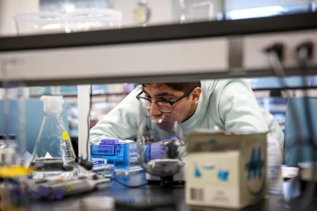 Student watches an experiment taking place in a science lab.