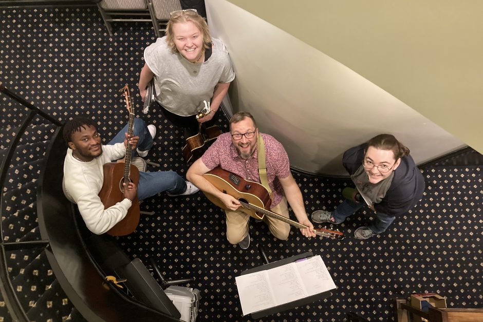 Michael Ossai (left), Audrey Pagel (top center), and Erin Fitzgerald (right) work with Cornell Artist Instructor of Voice Ben Laur (front center) who served as an in-house studio musician for students in the Songwriting course.