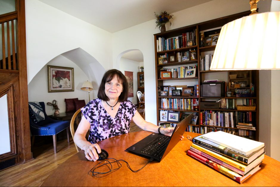 Carolyn Enns works at her living room table.