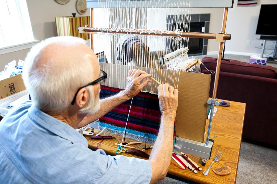 Chris Carlson works on his weaving project.