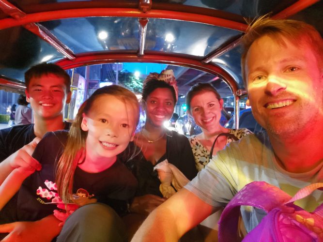 Scott Smiley ’96 (right) in a Tuk Tuk Taxi in Bangkok with (from left) his son Pacific Smiley, daughter River Tang Smiley, Allahna Brathwaite ’97, and Annie Gregory Reneau ’97.