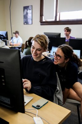 two students work together on a computer in the GIS lab.