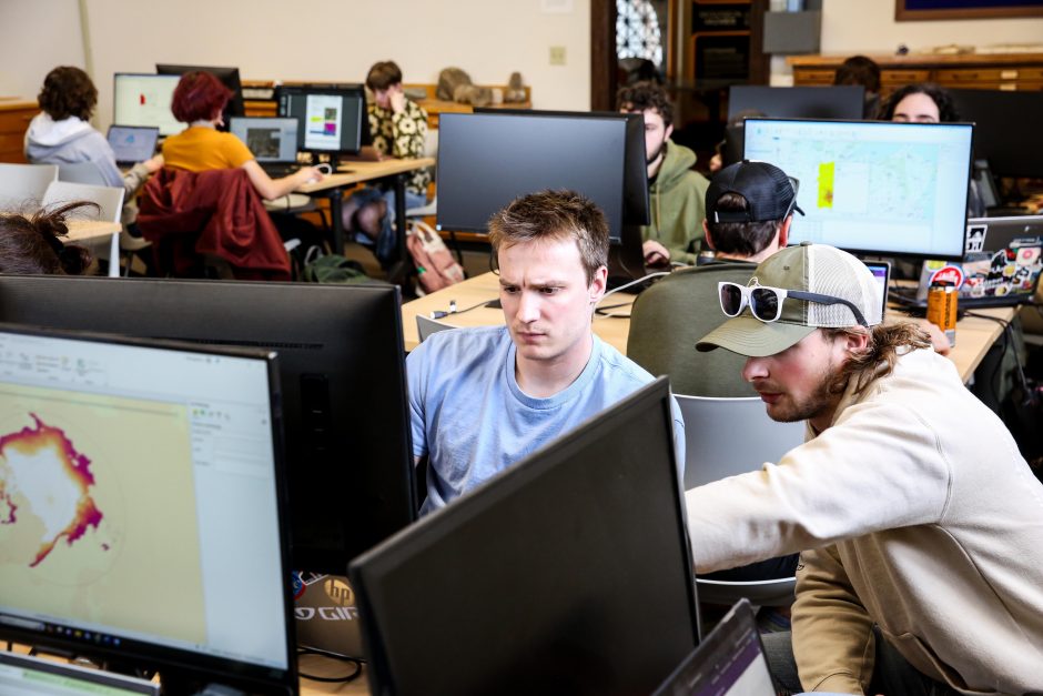 Two students work together on a computer in the GIS lab at Cornell College. One points to the screen.