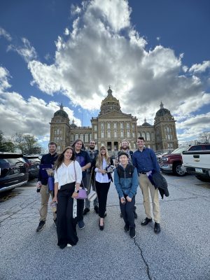 Students pose for a photo outside the Iowa State Capitol building. Photo by Megan Goldberg.