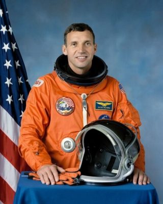 David Hilmers wearing an orange spacesuit