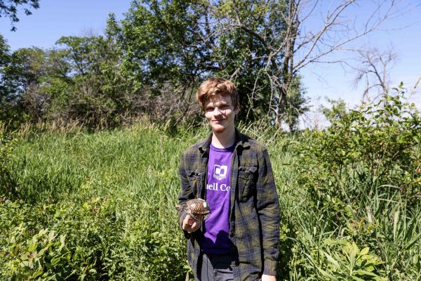 Peyton Bainbridge holds a turtle found with a transmitter.