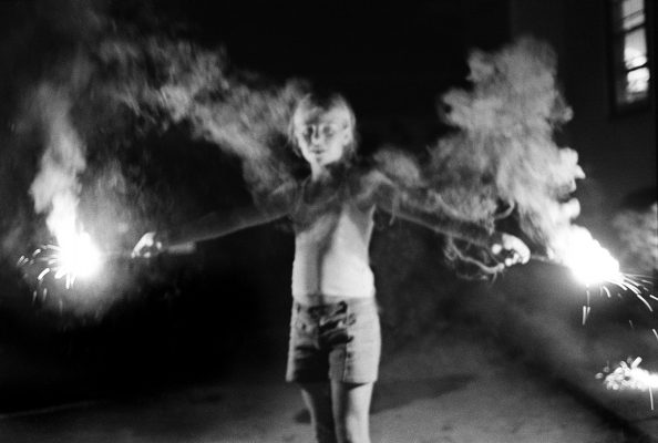 Child with sparklers in black and white photo