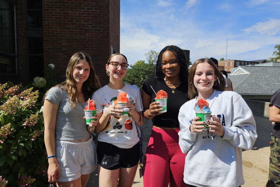 Four students stand with their Kona Ice snow cones.