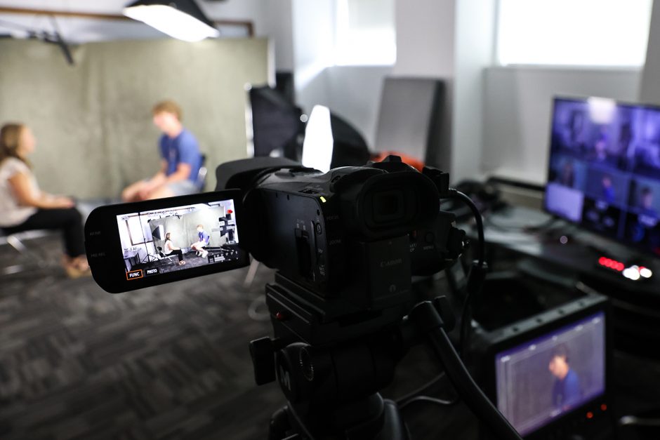 Student practicing interviewing on a multi-camera set.