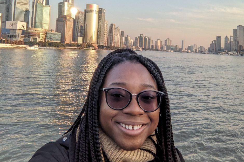 Kimberly Maitland ’24 with the Shanghai skyline behind her.