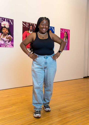 Safiyat Aminu ’24 is surrounded by the artwork for her senior thesis show, “SEEN,” at Peter Paul Luce Gallery. She now lives in Nashville, where she works for ArtistYear as a resident teaching artist in a Title 1 school. Photo by Sandra Dyas.