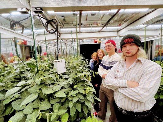 Students pose inside of one of the growing chambers at Bayer's Crop Science lab in Chesterfield, MO. Photo credit: Tyler Carrington