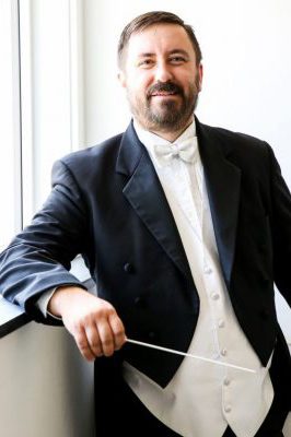 Joshua Neuenschwander, in tux with baton