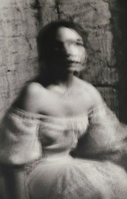 A film photo from Raffenaud's show that depicts a black and white blurry picture of a girl looking toward the viewer.